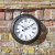 Outside In Biarritz Wall Clock 12in - Black